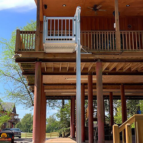 A Galaxy cargo lift installed beside a cable-rail deck on an elevated stilt home.