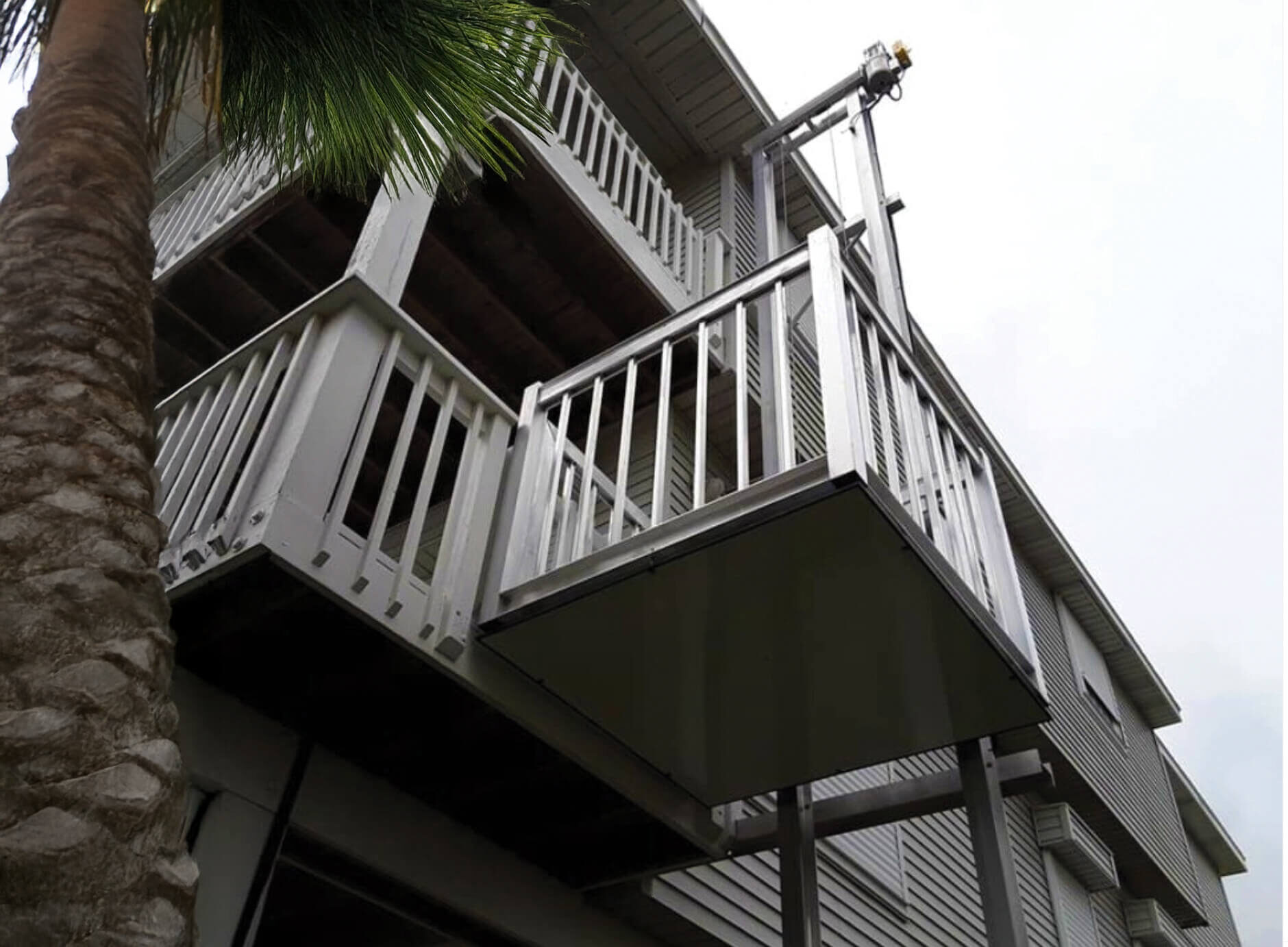 Galaxy Shuttle+ cargo lift on a multi-story gray coastal condo
