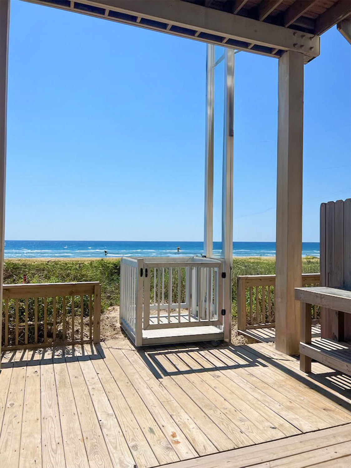 Galaxy Voyager+ cargo lift on a white beach-house deck with turquoise ocean beyond